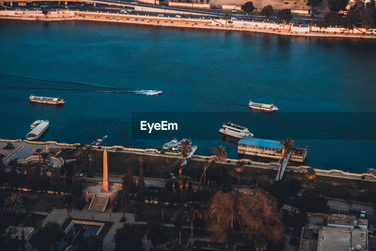 High angle view of commercial dock by sea against sky