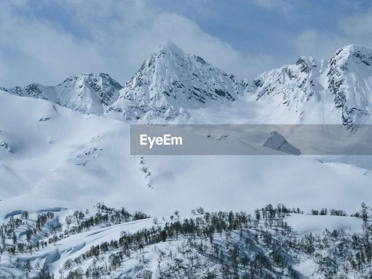 Scenic view of snow covered mountains against sky