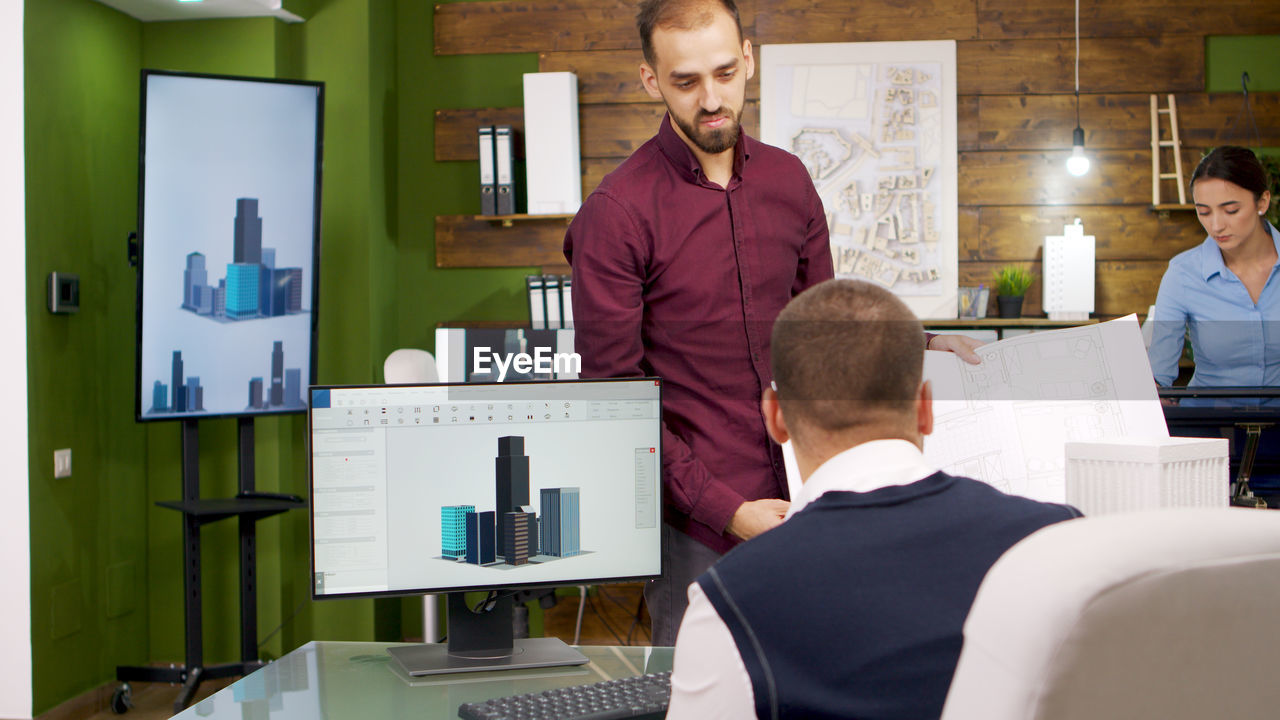 male friends working at desk in office