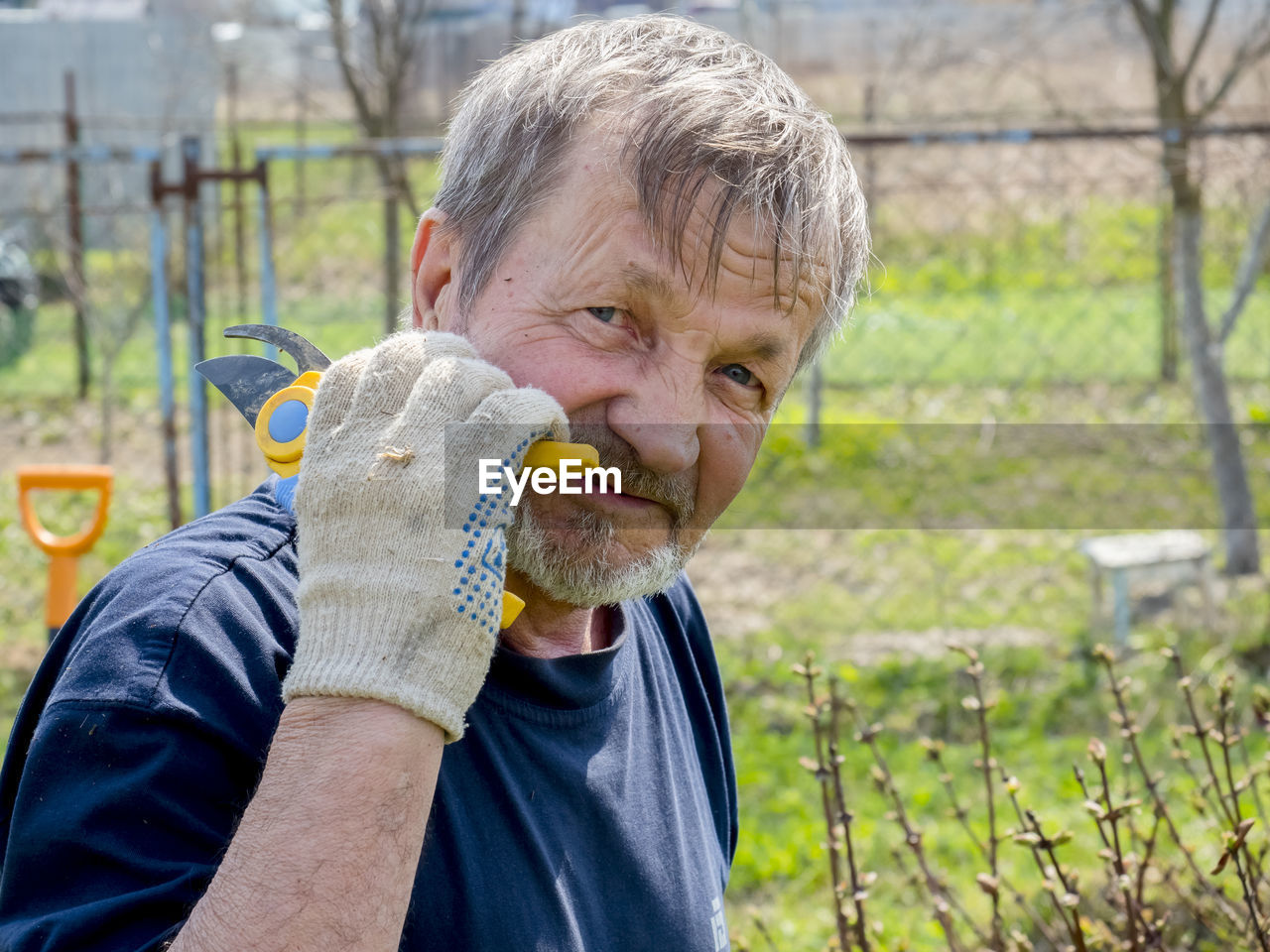 Portrait of man holding pruning shears