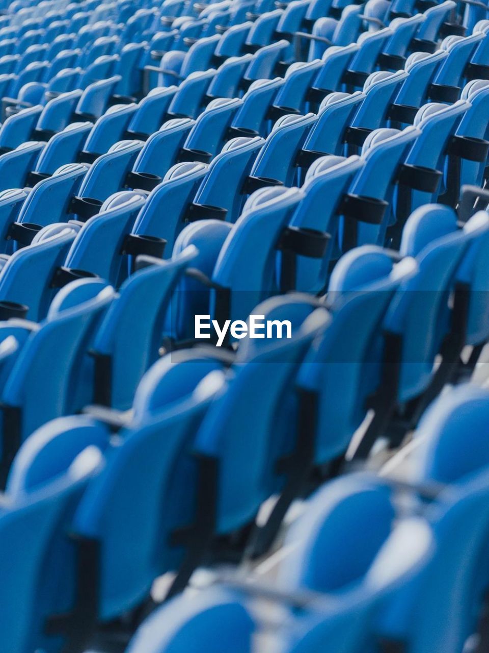 full frame shot of empty chairs at stadium