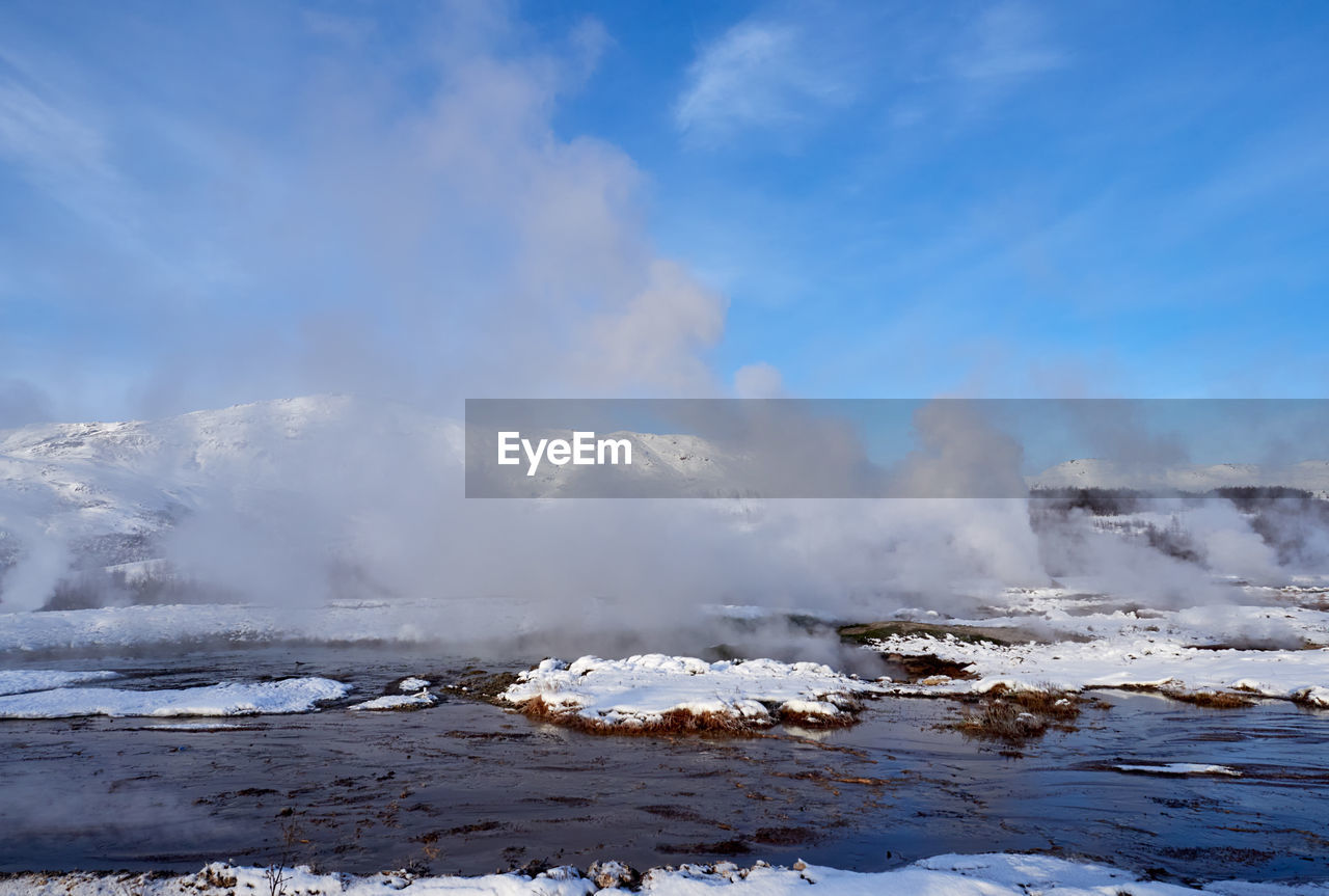 Hot water streams around strokkur geyser, iceland