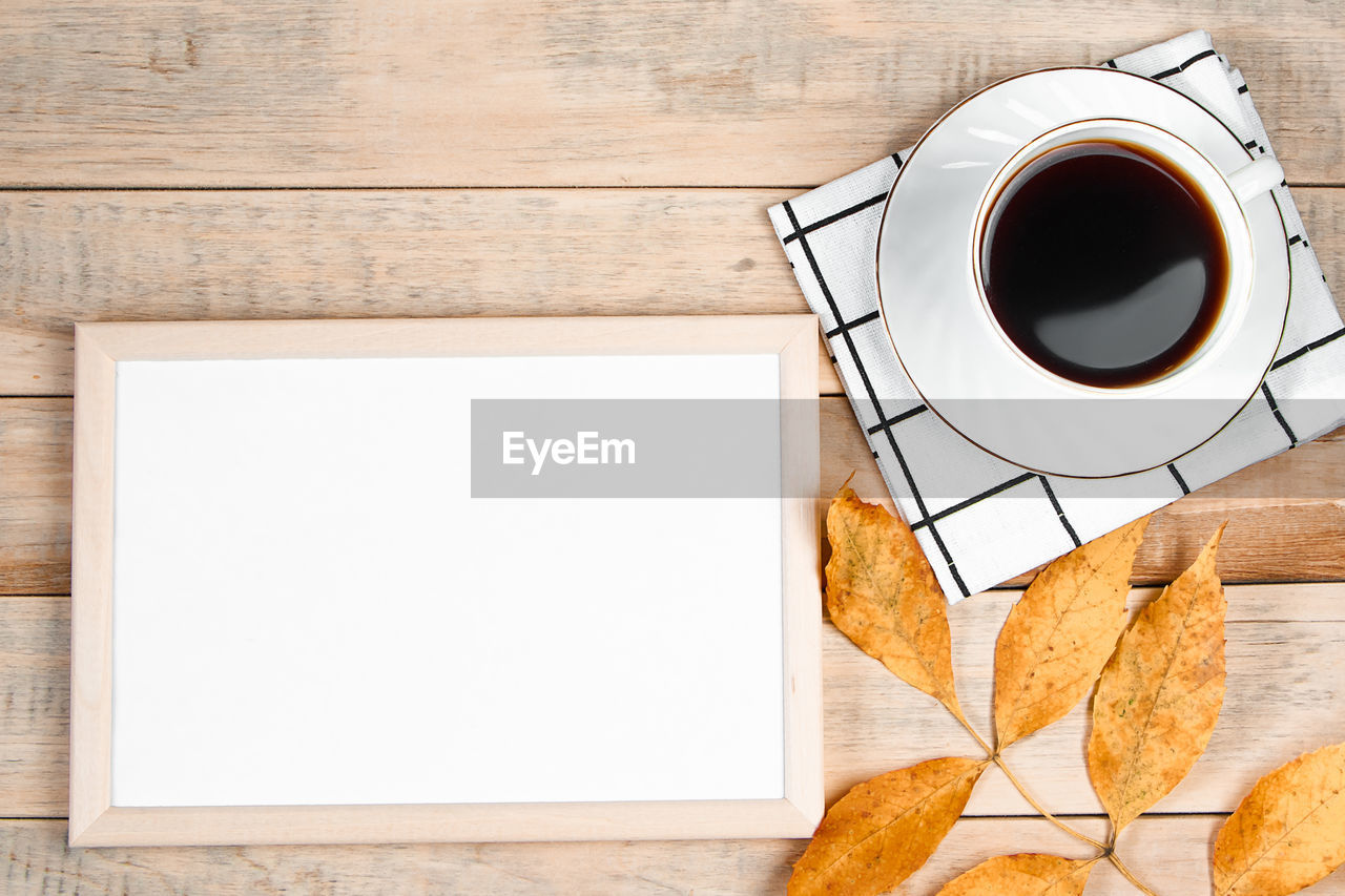 coffee, mug, cup, coffee cup, food and drink, wood, drink, directly above, table, copy space, paper, refreshment, hot drink, no people, black coffee, indoors, food, tea, still life, high angle view, crockery, studio shot, freshness