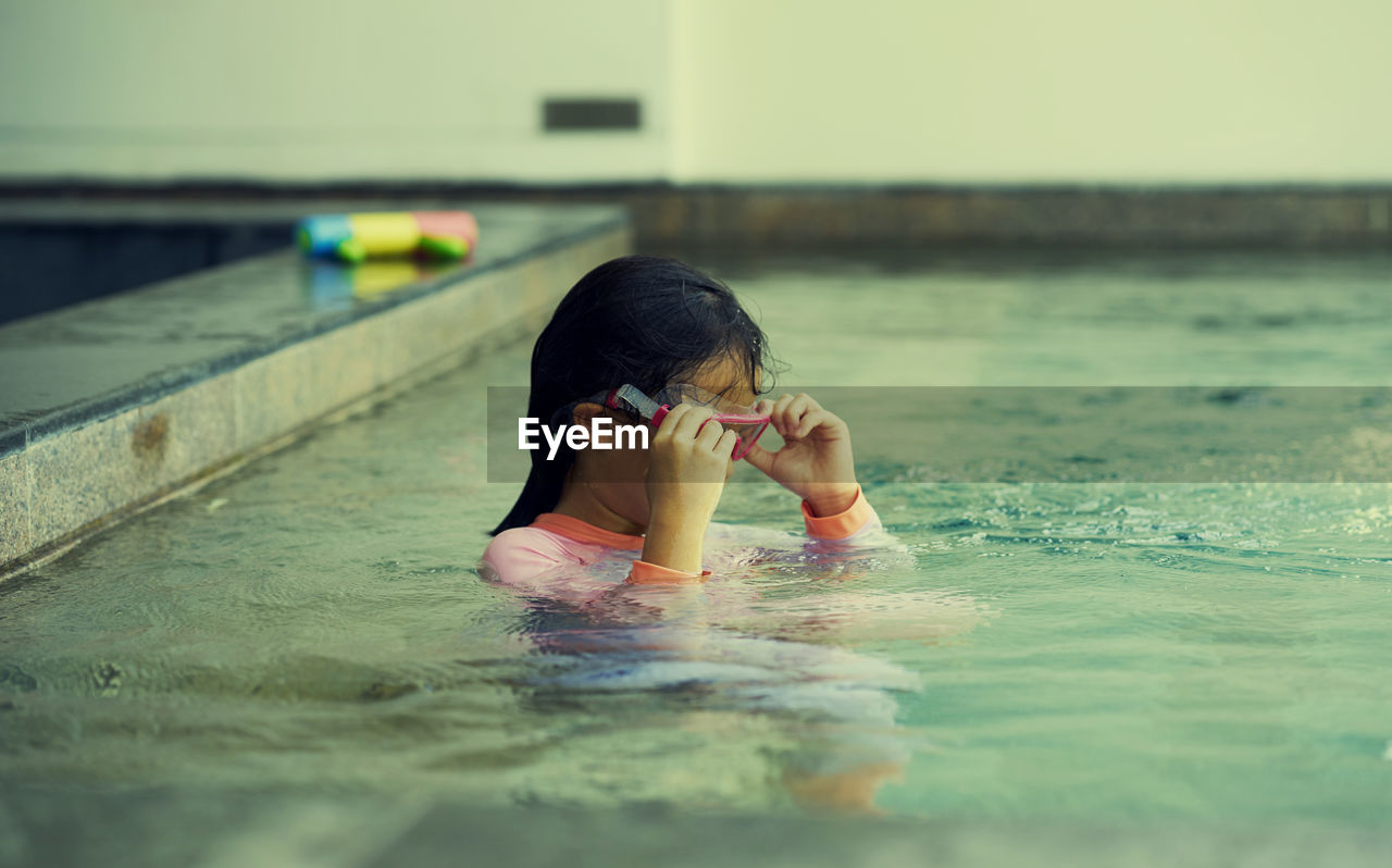 Portrait of woman swimming in pool