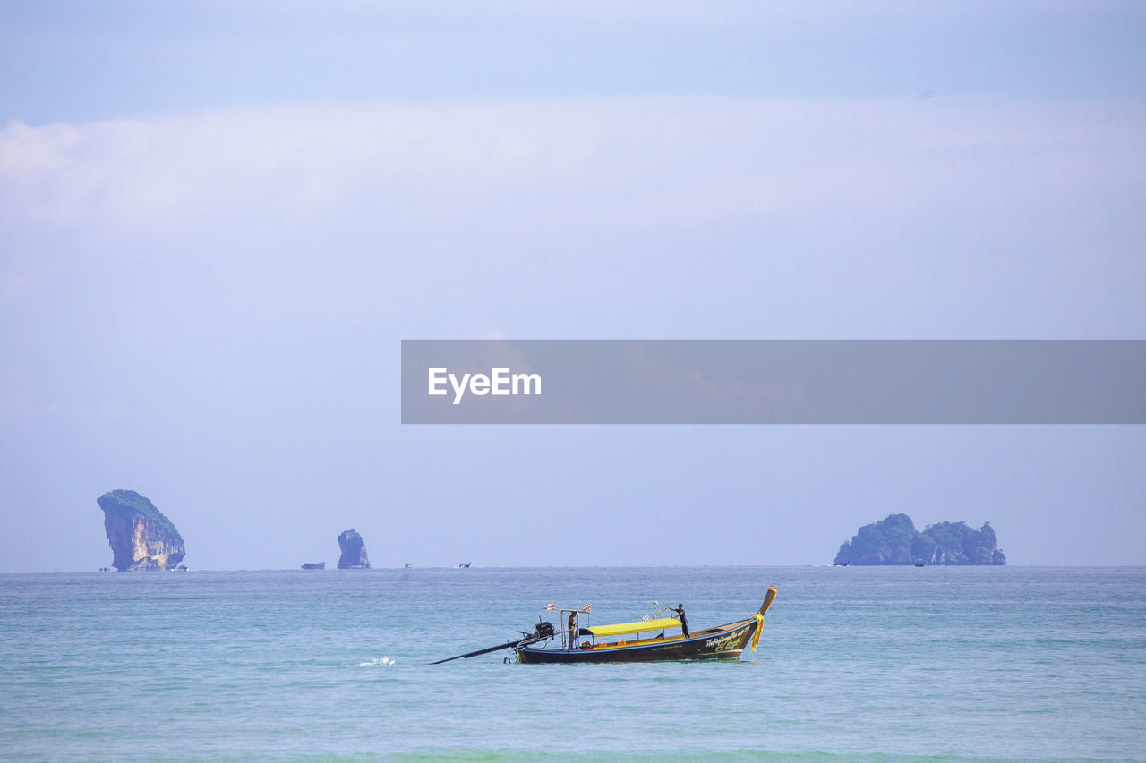 water, nautical vessel, sea, transportation, sky, travel, ocean, mode of transportation, nature, vehicle, boat, horizon, beauty in nature, scenics - nature, bay, travel destinations, shore, land, beach, watercraft, blue, holiday, coast, tourism, trip, vacation, cloud, outdoors, tranquility, wave, boating, day, environment, horizon over water, ship, tranquil scene, landscape, seascape, long-tail boat, sailing
