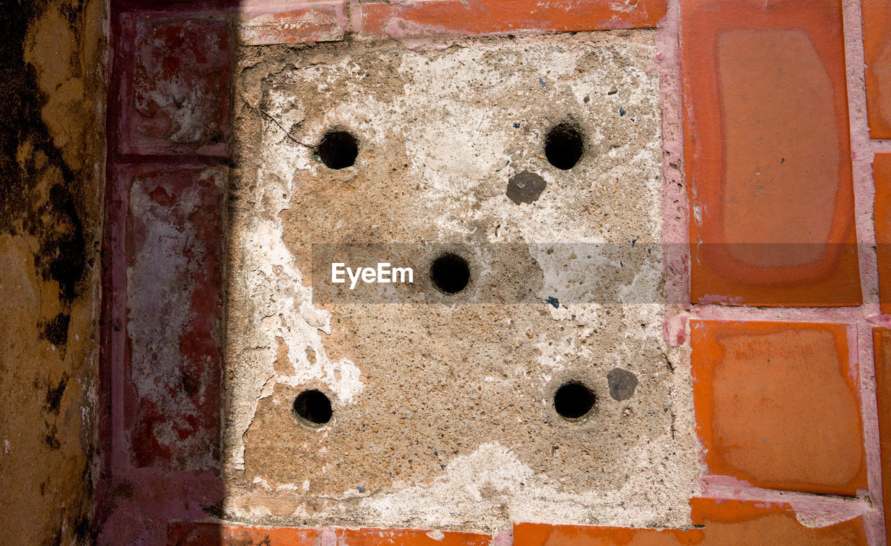 Close-up of holes on footpath