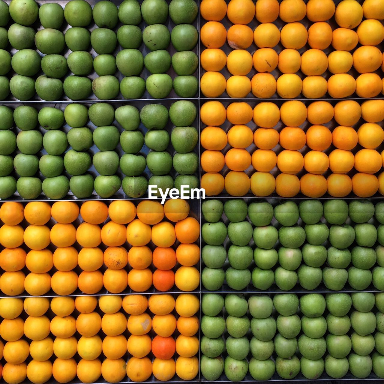 Full frame shot of granny smith apples and honeydew melons at market