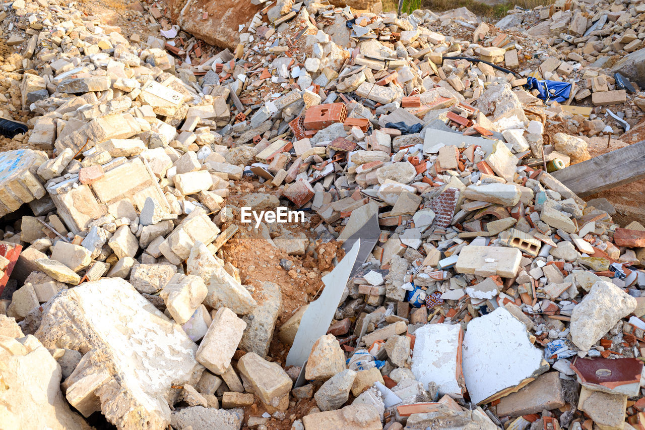 HIGH ANGLE VIEW OF GARBAGE ON PEBBLES