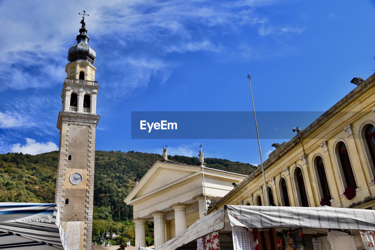 architecture, built structure, building exterior, landmark, sky, building, travel destinations, religion, tower, place of worship, town, nature, belief, history, travel, city, the past, spirituality, tourism, cloud, blue, day, outdoors, bell tower, no people, clock tower, catholicism, street