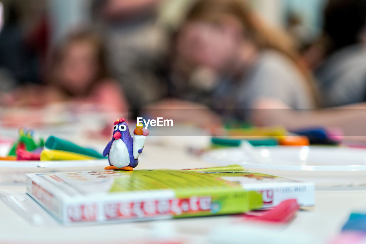 Close-up of toy on book at table