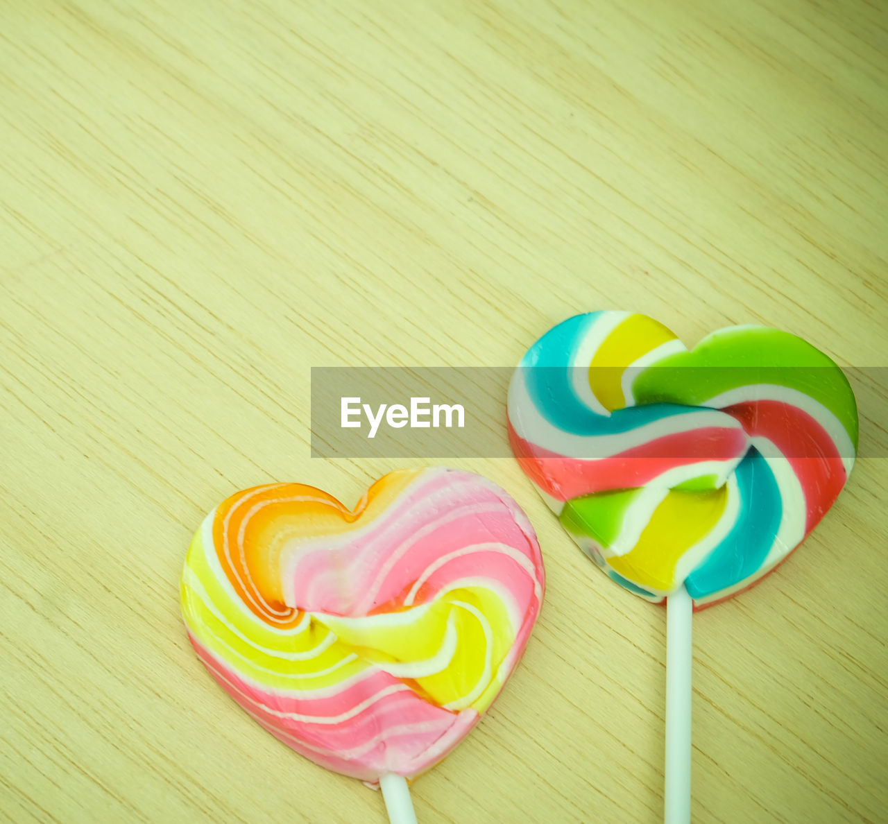 Close-up of colorful heart shape lollipops on table