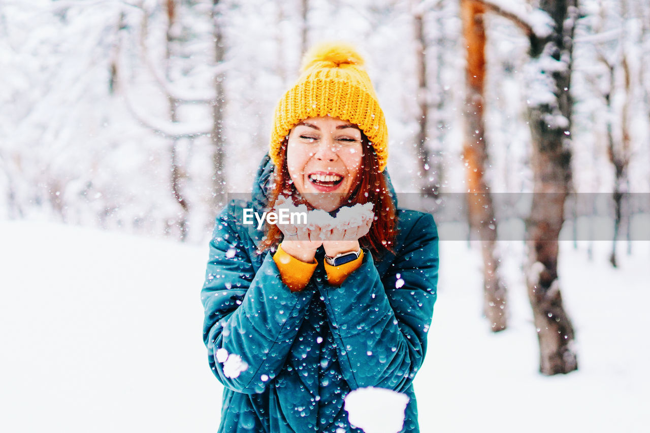 portrait of woman standing on snow during winter