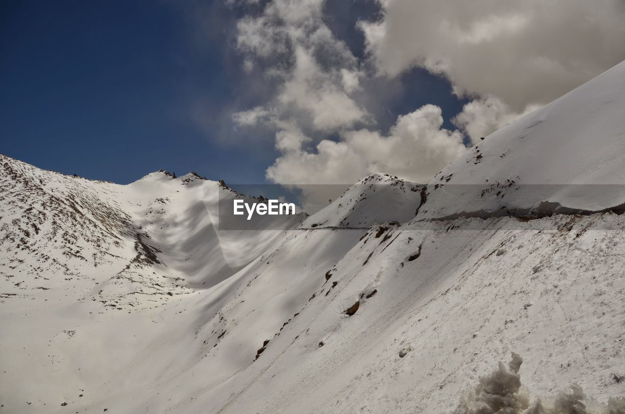 Low angle view of snow on mountain against sky