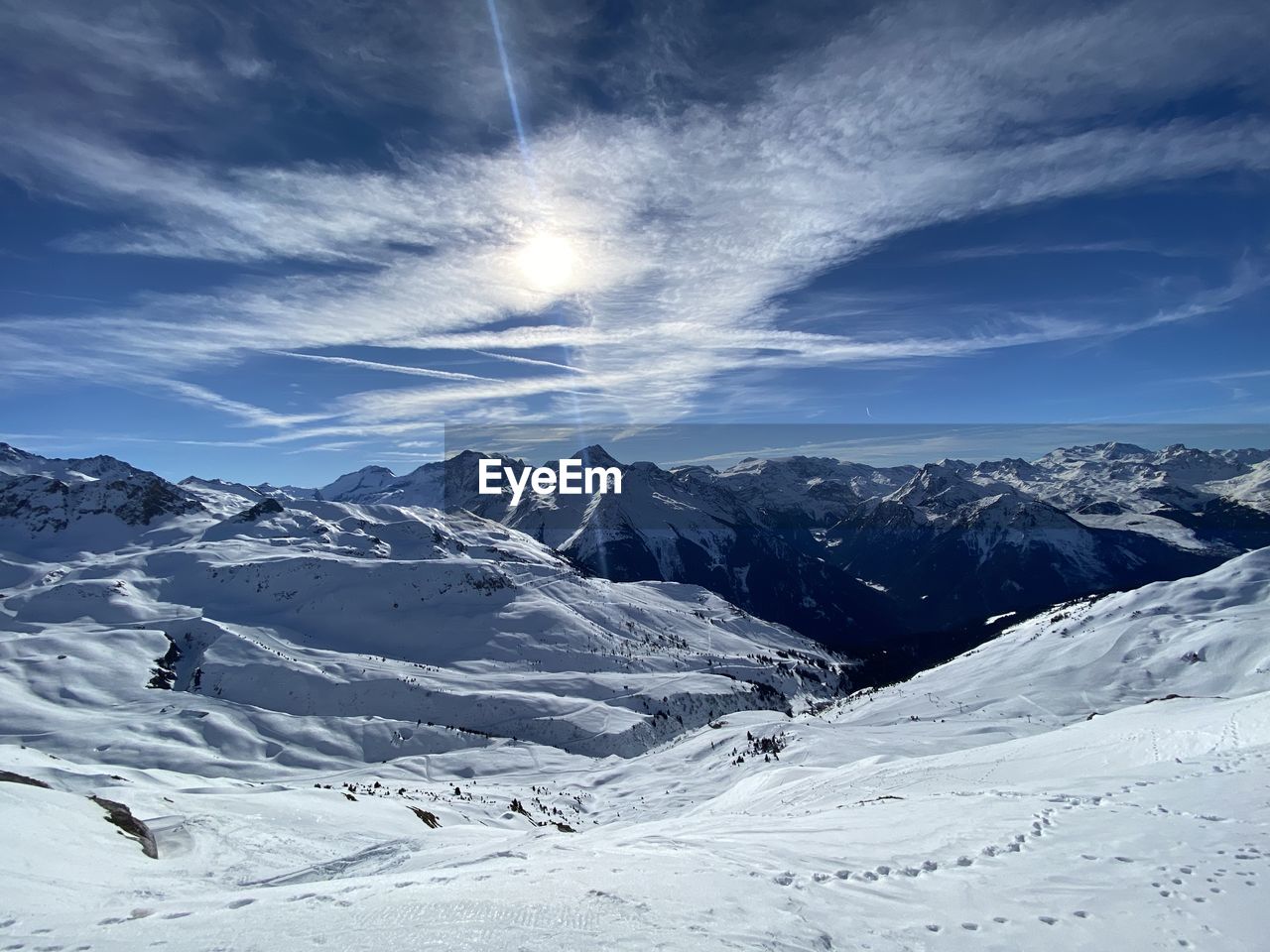 Scenic view of snow covered mountains against sky