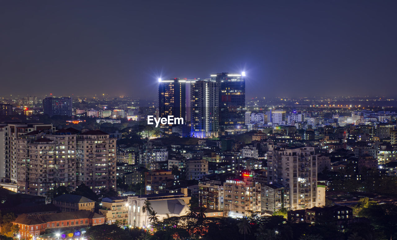 High angle view of illuminated city buildings at night