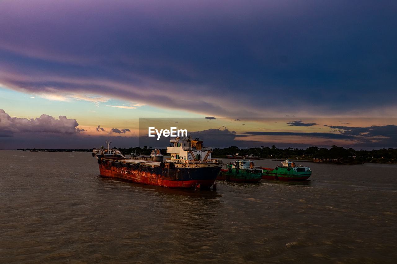 water, nautical vessel, sky, sea, transportation, sunset, cloud, mode of transportation, nature, coast, ocean, land, travel, environment, boat, vehicle, dusk, landscape, beach, bay, evening, ship, shore, travel destinations, beauty in nature, scenics - nature, watercraft, horizon, dramatic sky, seascape, outdoors, reflection, no people, tourism, architecture, tranquility, night, holiday, vacation, fishing, trip, coastline, craft