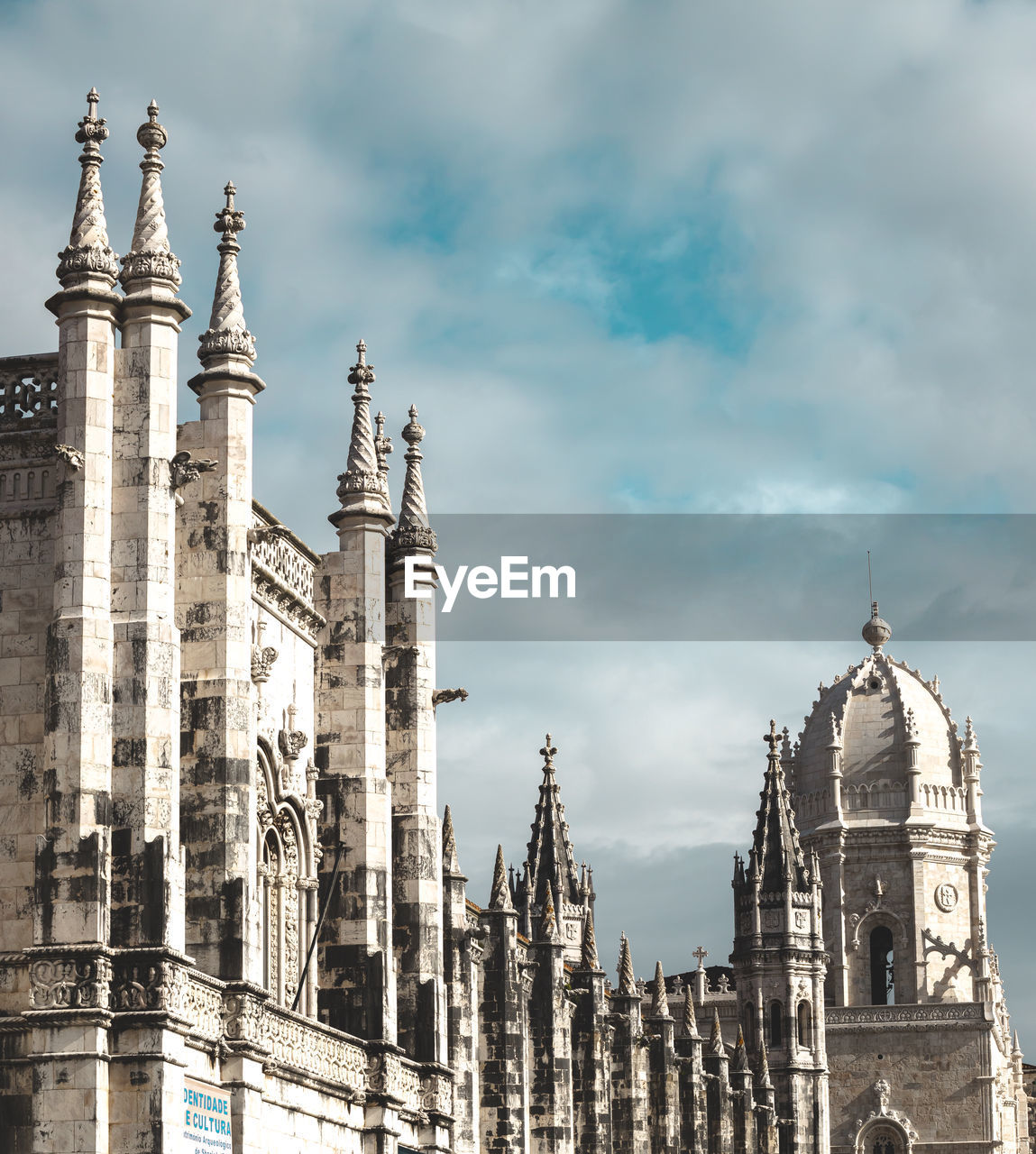 Low angle view of buildings against cloudy sky