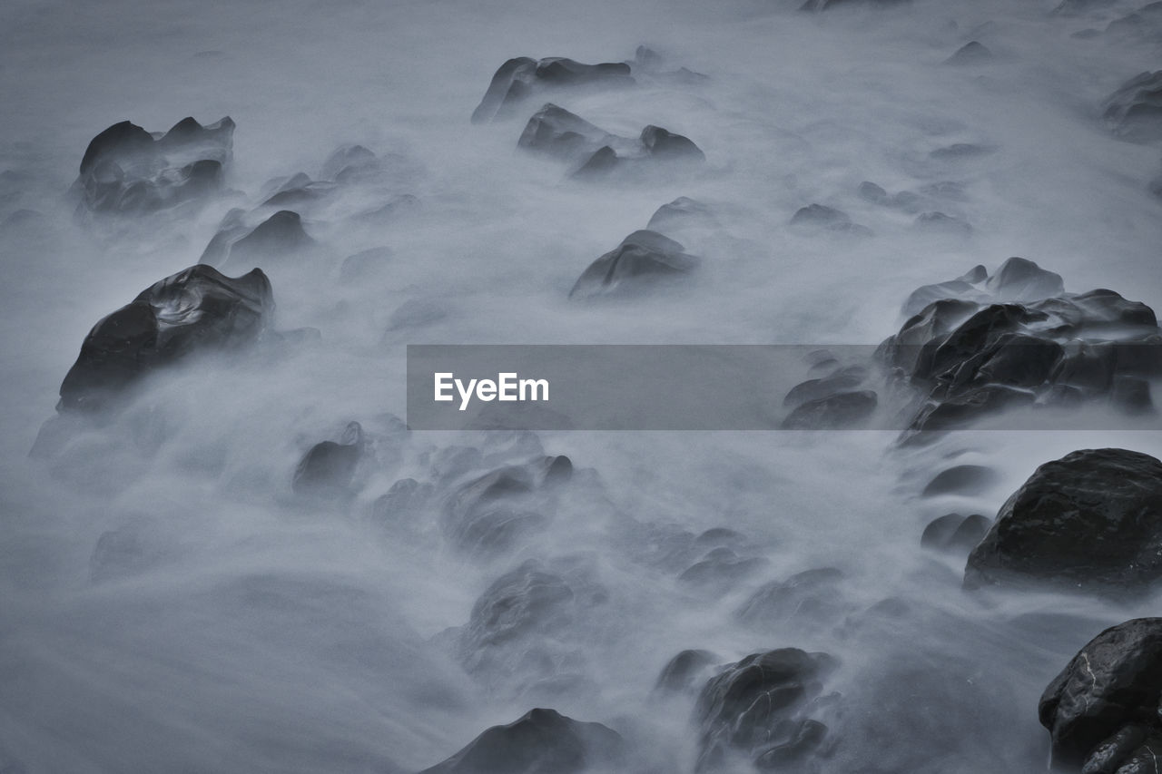 Aerial view of rocks in sea