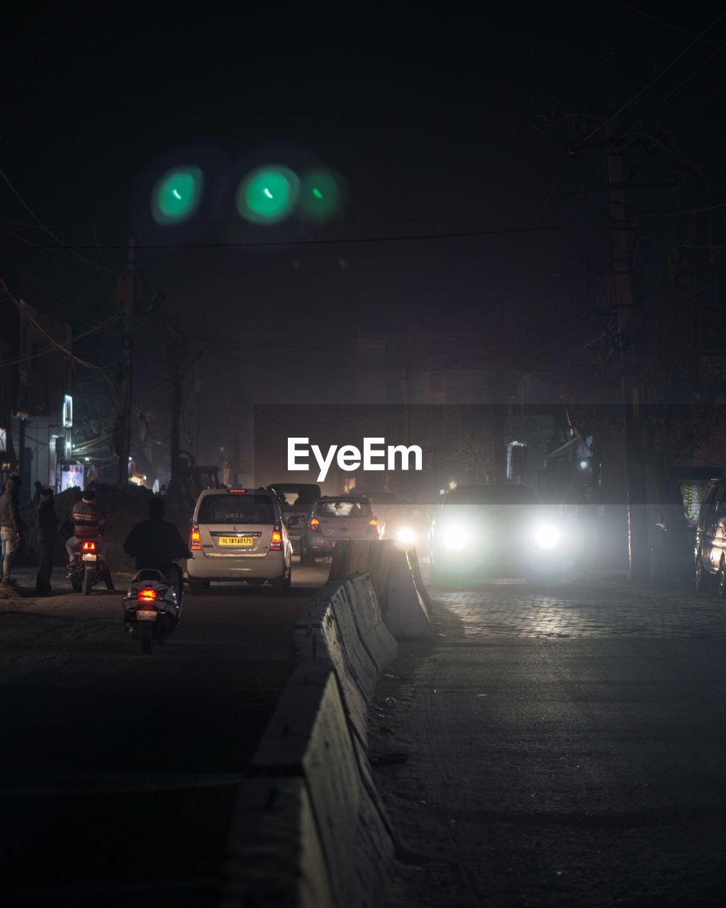 CARS ON ILLUMINATED CITY STREET