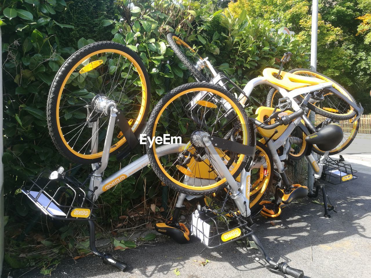 BICYCLE PARKED BY YELLOW WALL