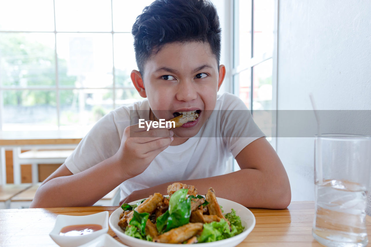 Boy eating fried chicken