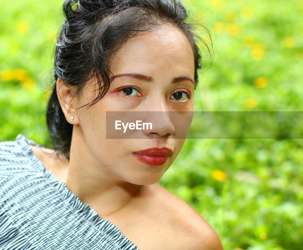 Close-up portrait of woman on field