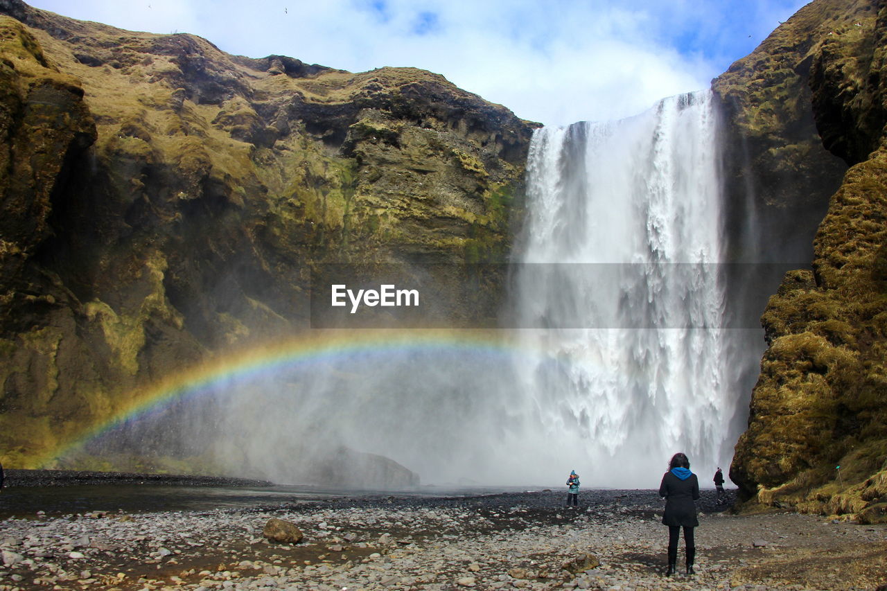 SCENIC VIEW OF WATERFALL IN MOUNTAINS