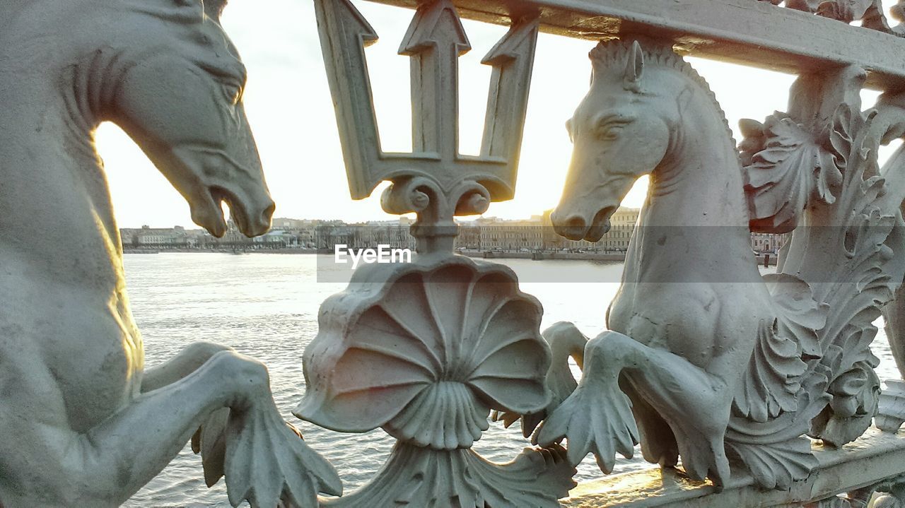 Close up view of part of bridge railing with horse representations