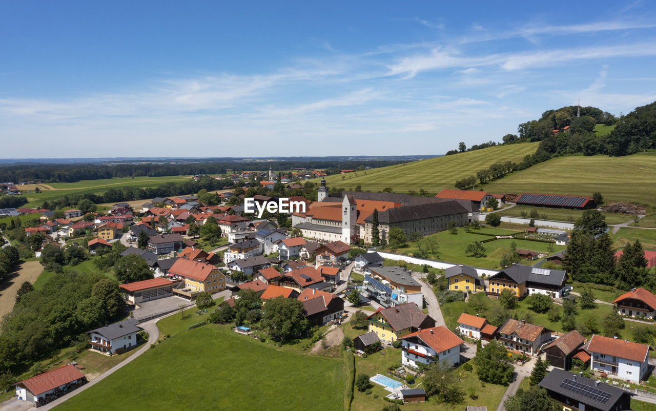 Austria, salzburger land, dorfbeuern, drone view of michaelbeuern abbey and surrounding village in summer