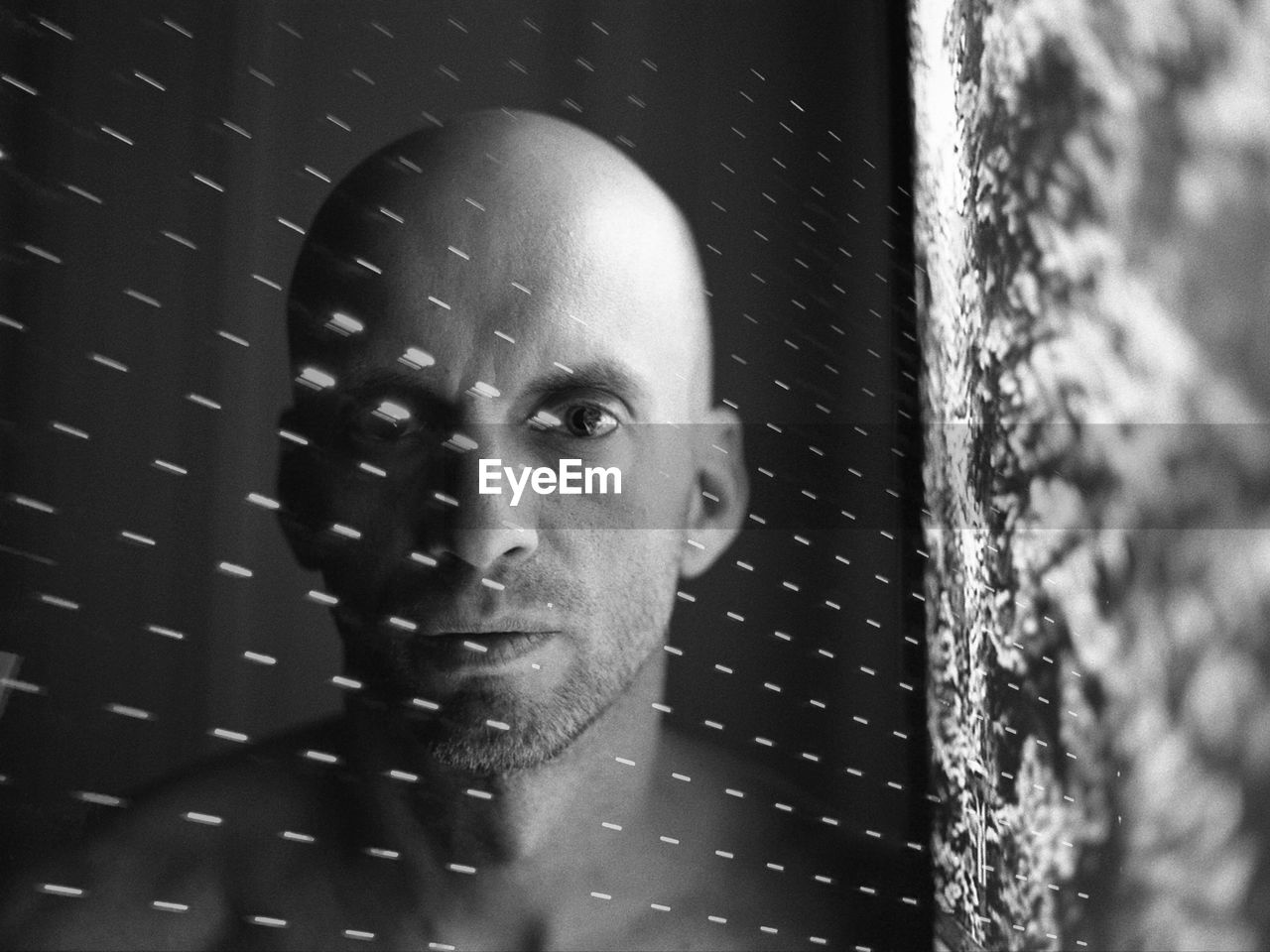 Digital composite image of bald man and light