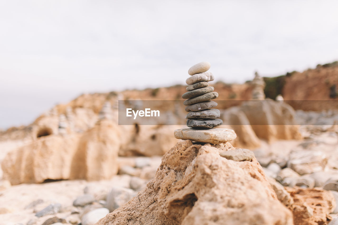 Close-up of stack of pebbles against sky