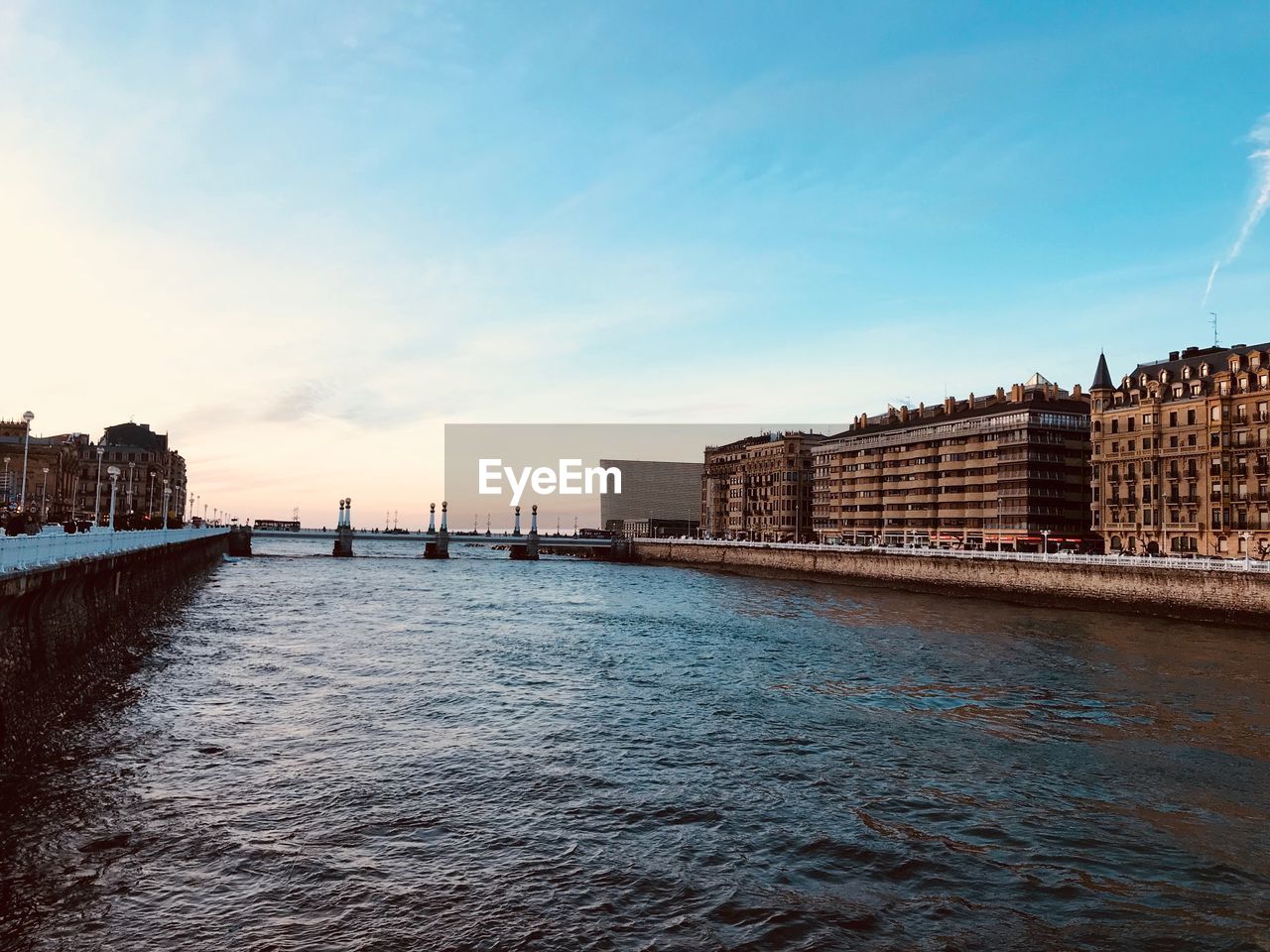 View of buildings by sea against sky