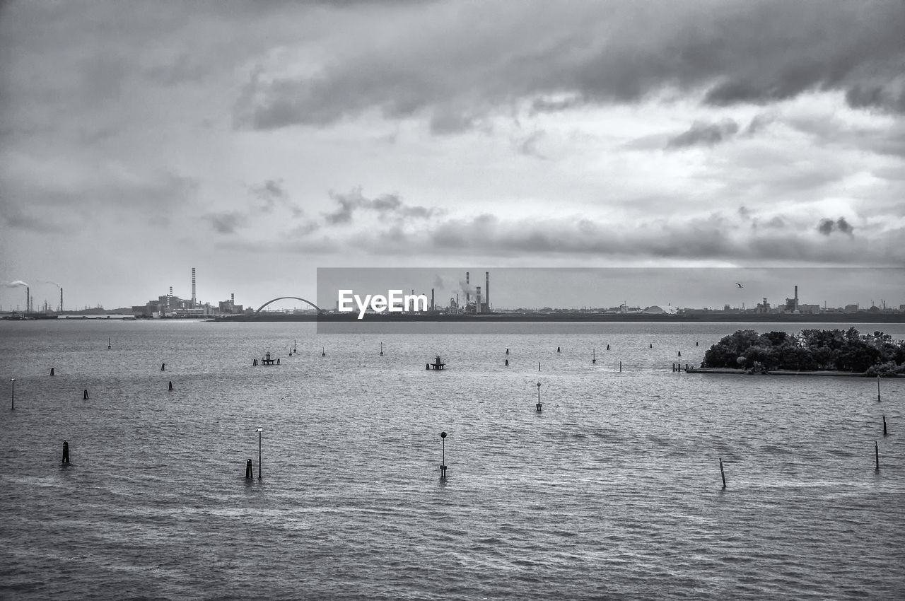 PANORAMIC VIEW OF BOATS IN SEA AGAINST SKY