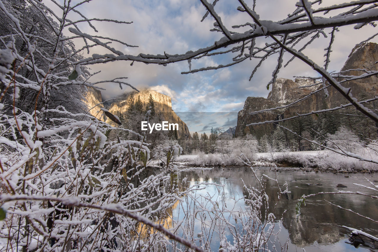 FROZEN LAKE AGAINST SKY DURING WINTER