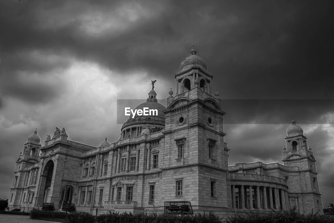 Low angle view of building against cloudy sky