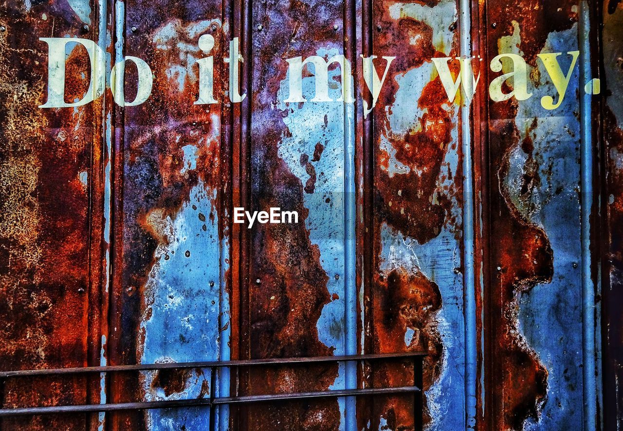 Full frame shot of rusting metal door