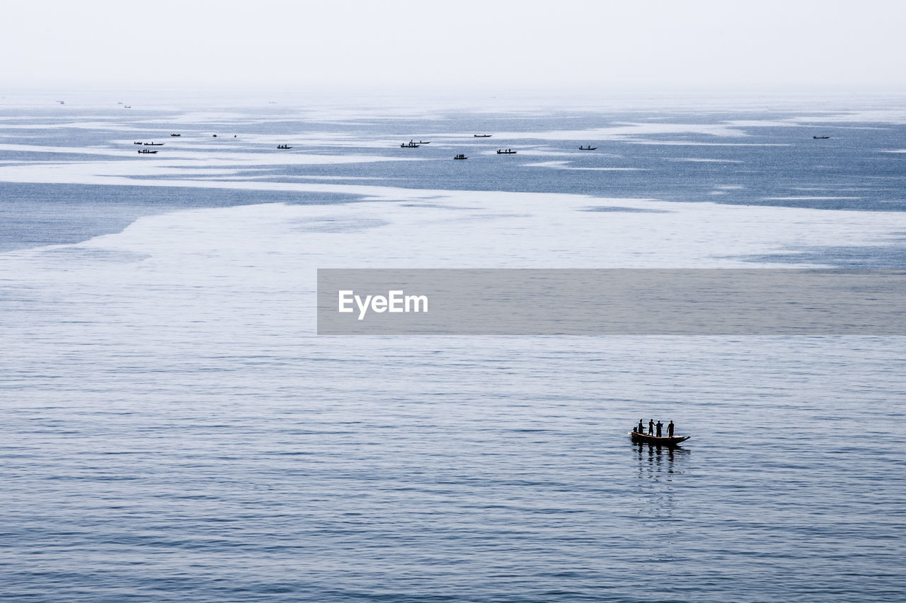 People in boat on sea