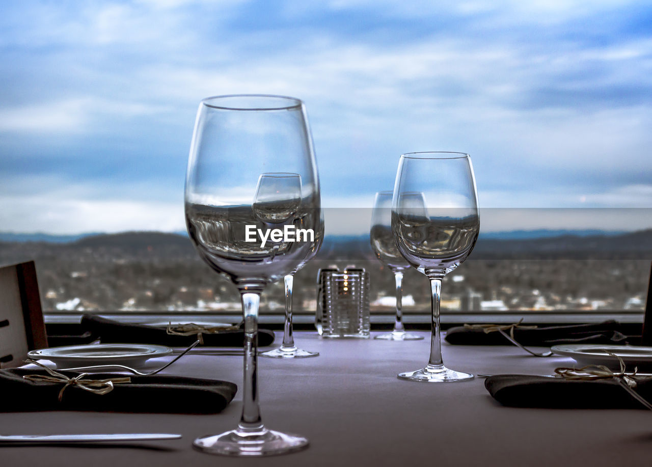 Wineglasses on table against window