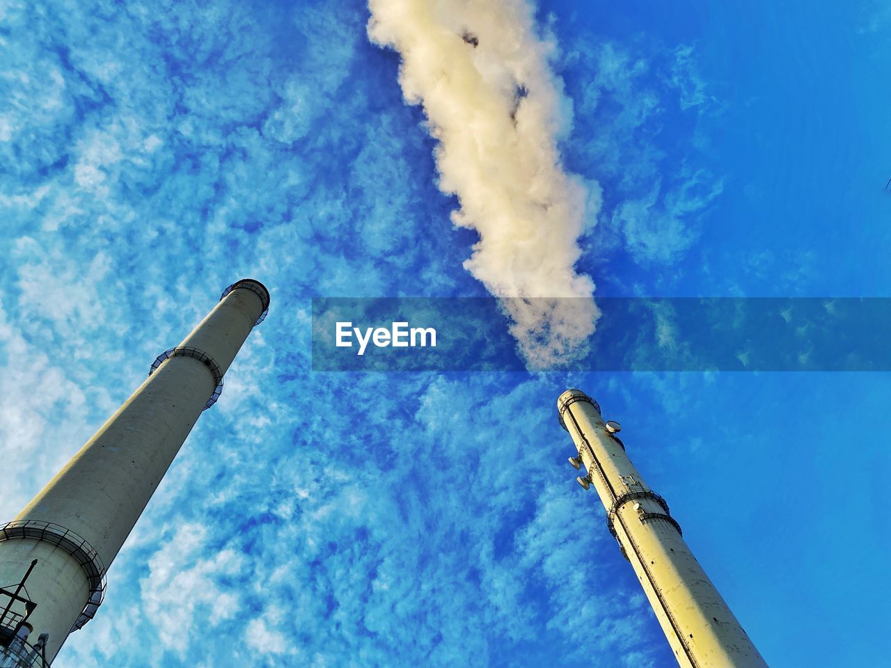 blue, sky, cloud, low angle view, rocket, spacecraft, no people, smoke stack, smoke, vehicle, nature, missile, day, architecture, outdoors, industry, pollution, factory, weapon, air pollution