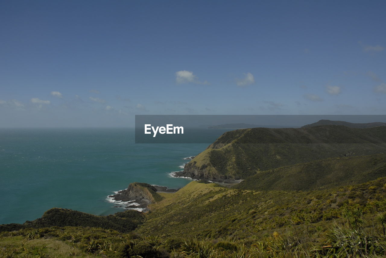 Scenic view of sea and mountains against sky