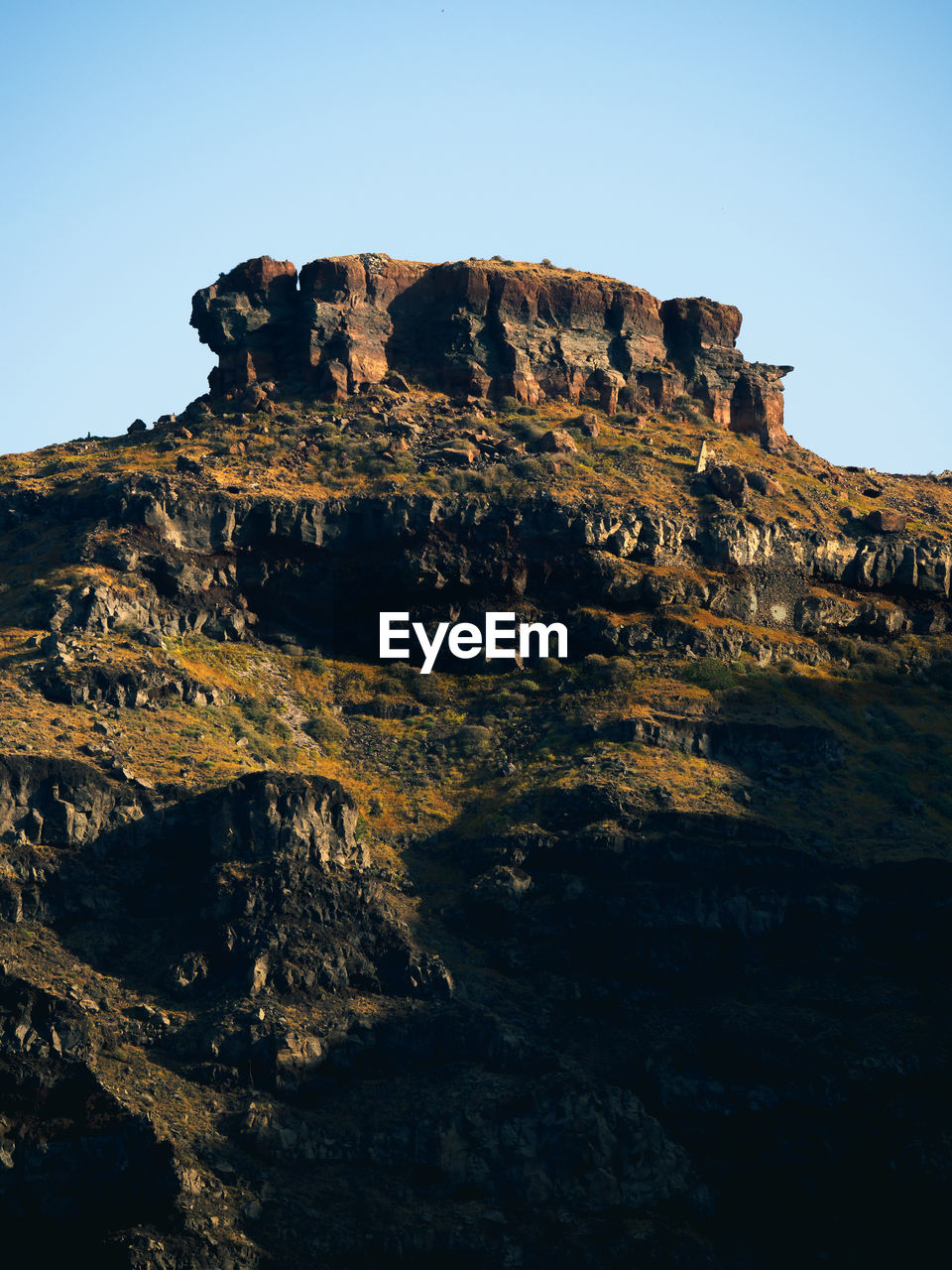 rock, sky, nature, mountain, rock formation, environment, landscape, scenics - nature, beauty in nature, clear sky, terrain, travel destinations, no people, land, cliff, non-urban scene, travel, geology, outdoors, blue, tranquility, formation, day, extreme terrain, sea, tranquil scene, physical geography