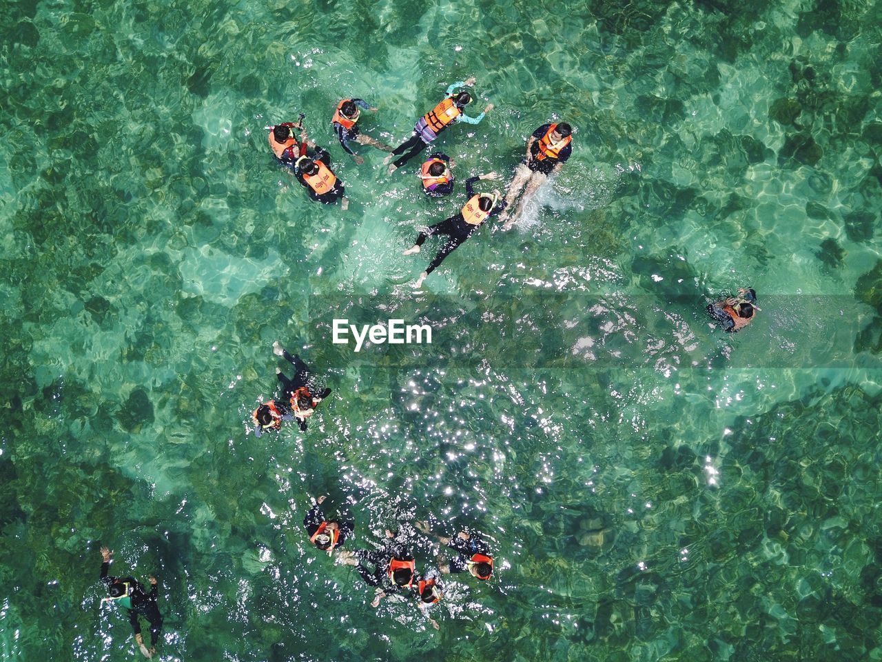 High angle view of people swimming in sea