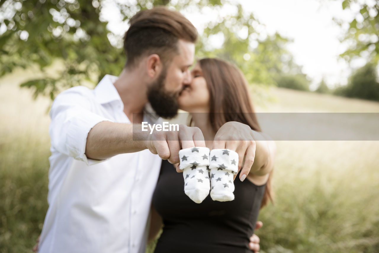 side view of couple sitting on land