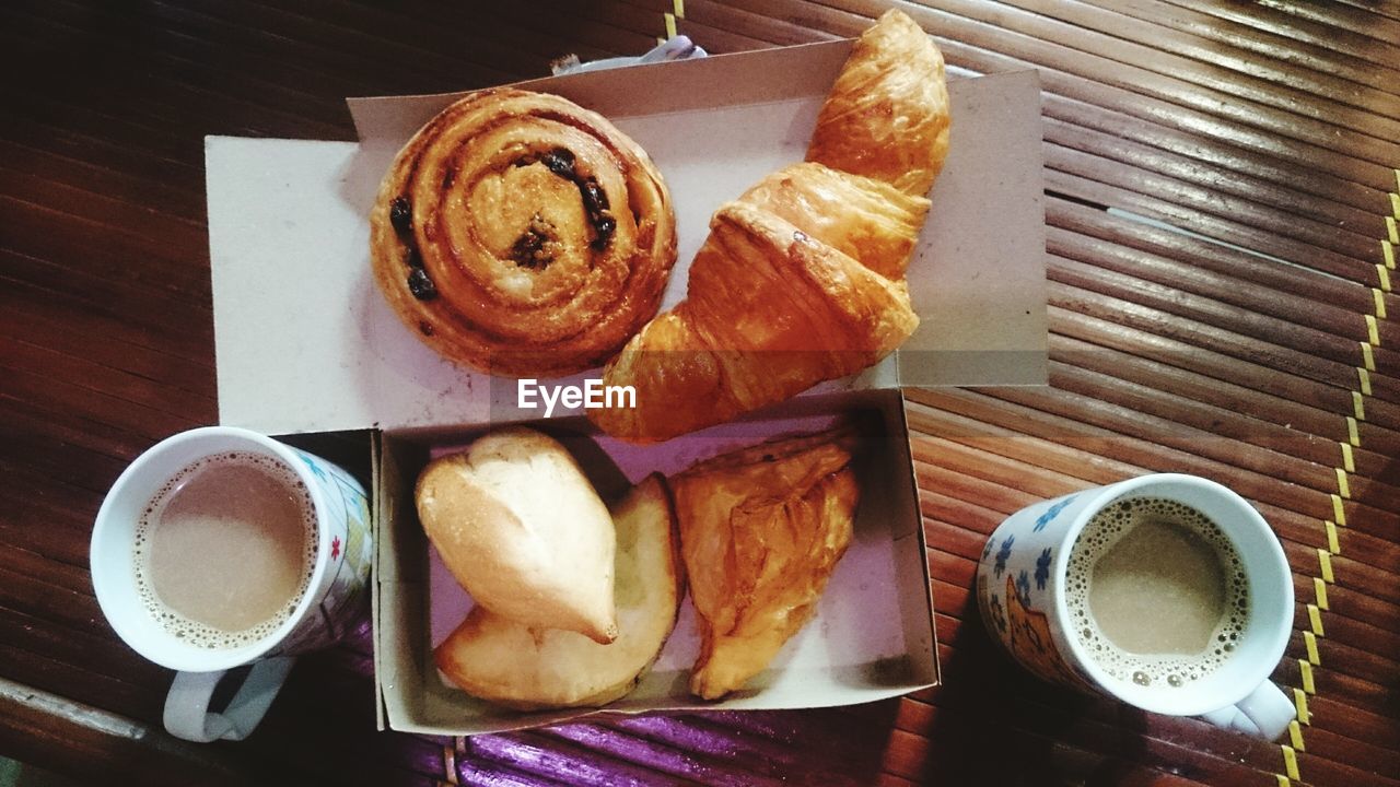 High angle view of breakfast and coffee on wooden table