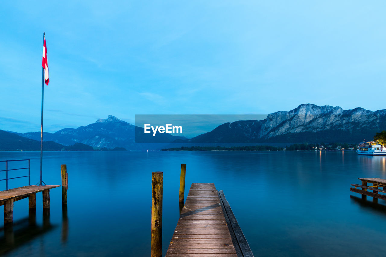 Pier over lake against mountains