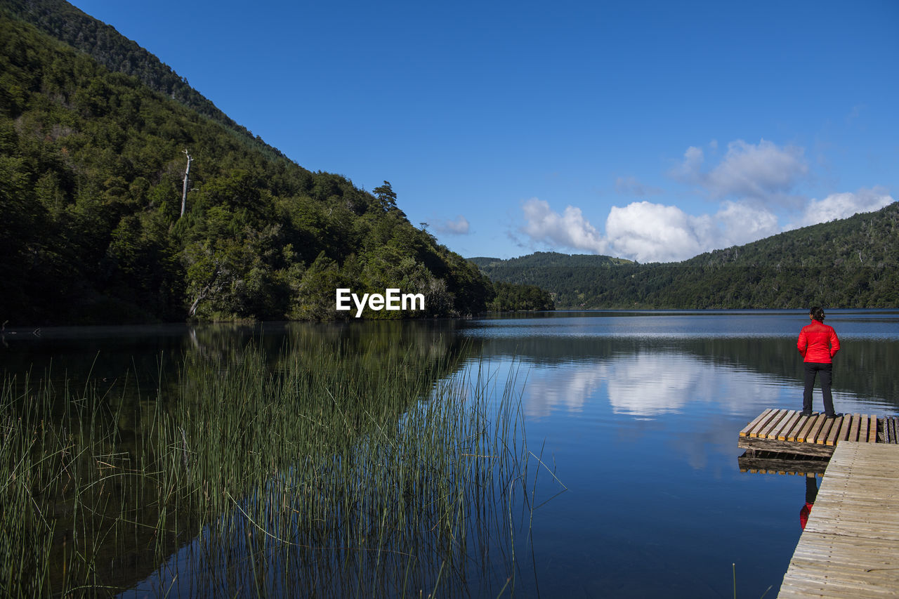 Woman admiring still lake at the chilean lake district