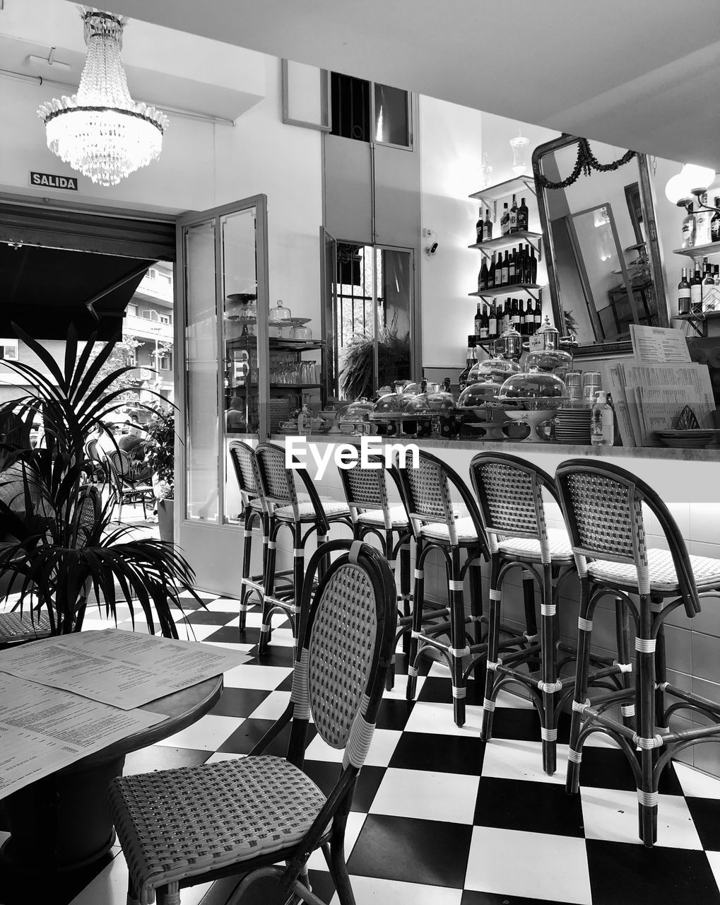 chair, seat, room, table, black and white, indoors, restaurant, interior design, cafe, business, monochrome, no people, architecture, furniture, monochrome photography, white, empty, flooring, building, built structure, food and drink, lighting equipment, absence