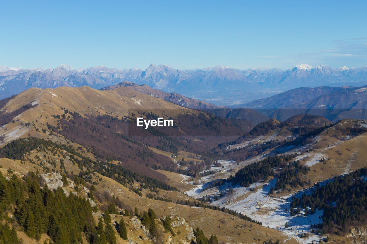 SCENIC VIEW OF MOUNTAINS AGAINST BLUE SKY