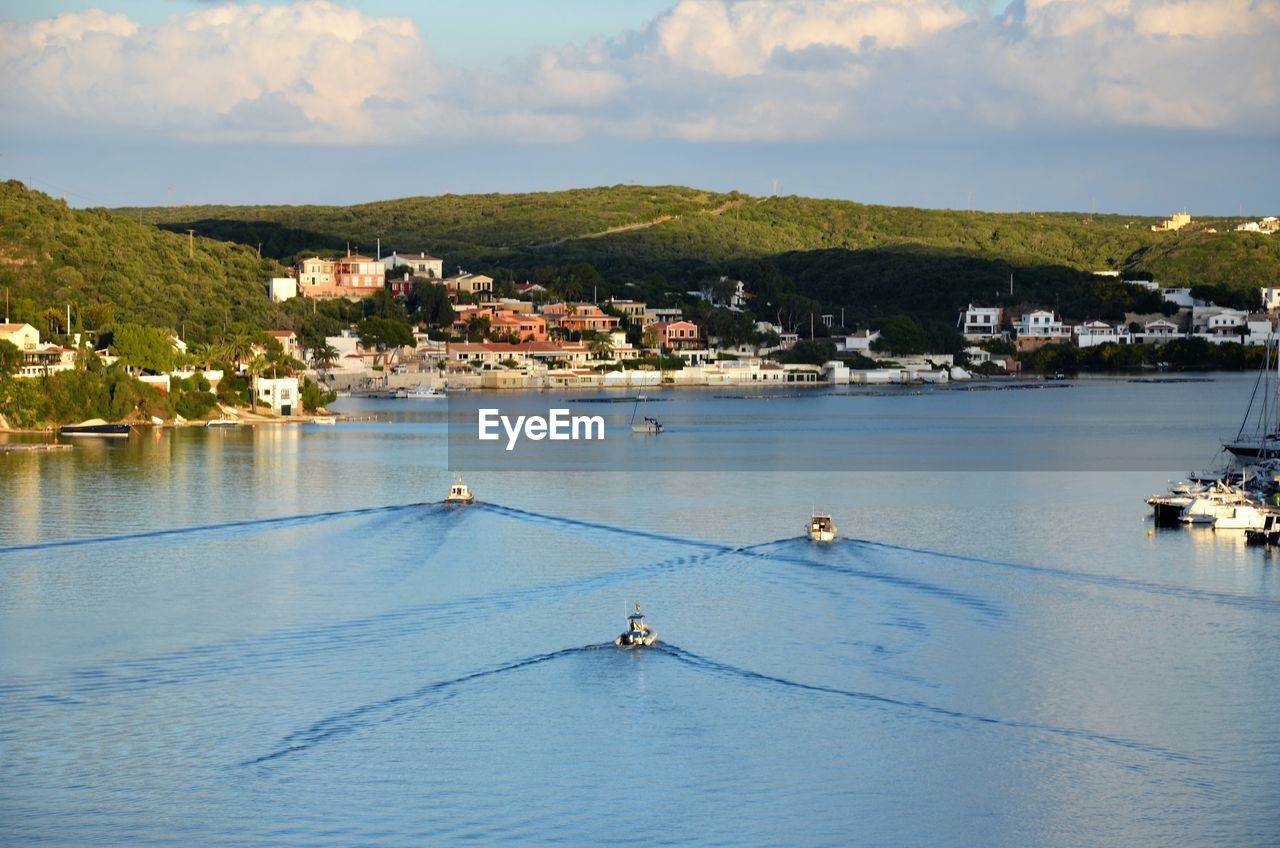 Scenic view of sea by buildings against sky