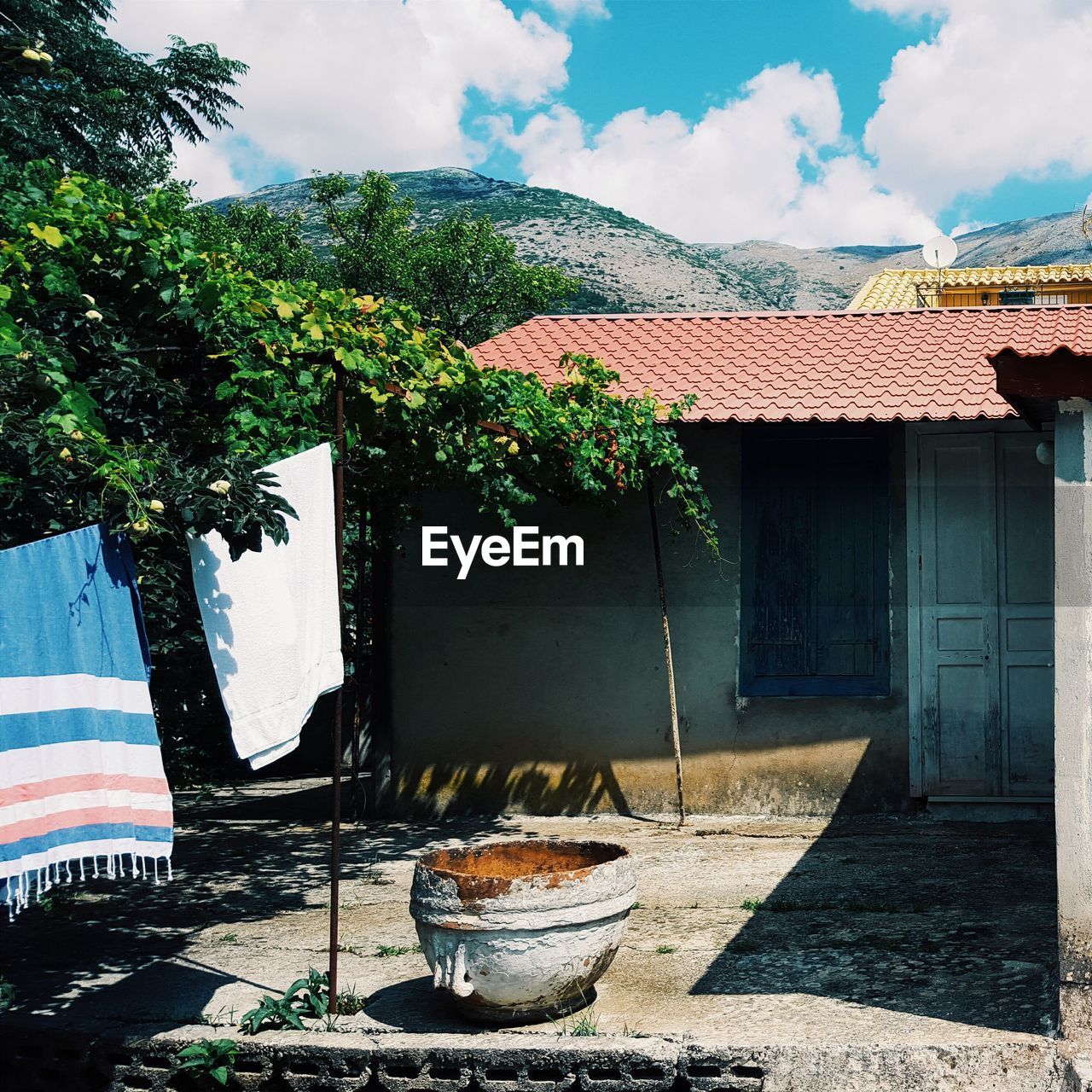 Laundry handing by house against mountain